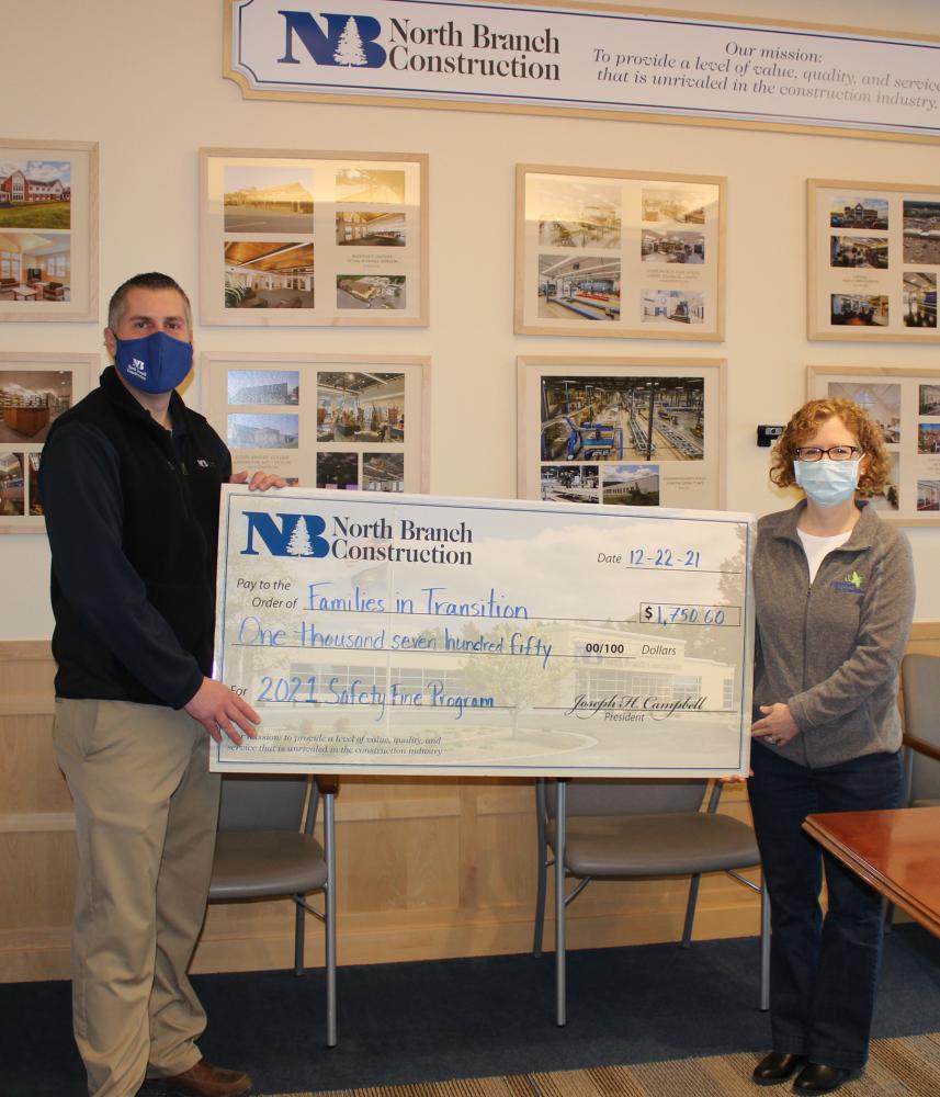 North Branch Construction President, Joseph Campbell, presents Families in Transition Philanthropy Officer, Michelle Casale, with a donation from the firm’s 2021 Safety Fine Program. 